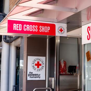 The outside of a retail store with sign reading "Red Cross Shop".