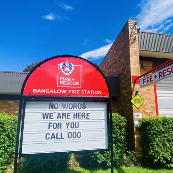 Outside Bangalow Fire Station the sign reads "No words, we are here for you call 000".