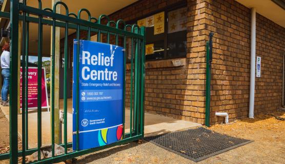 A sign for a Relief Centre is visible on a fence.