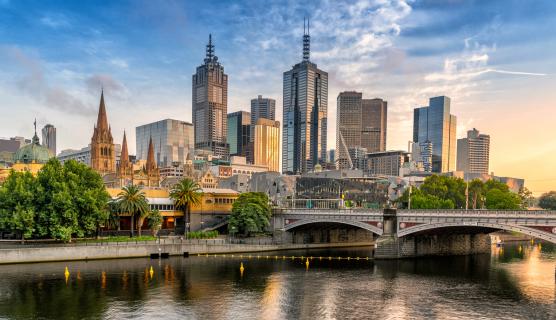 A high contrast image of Melbourne city with the river visible in the front of the frame and tall buildings in the back.