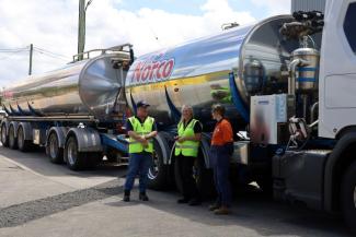 A photo of three Norco employees in front of a truck