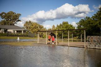 An image of two young children observing flood waters